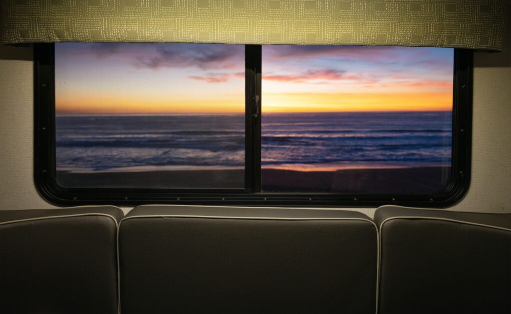 Scenic Ocean Sunset Through Motor Home RV Window